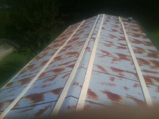 Rusted metal roof panels with new wood purlins before replacement — Storm Damage Roof Repair in Summerville by Roofing Brothers